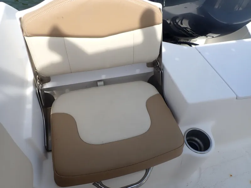 Slide: The Image of 2014 Robalo R200 Center Console boat seat with beige and white upholstery. - 16