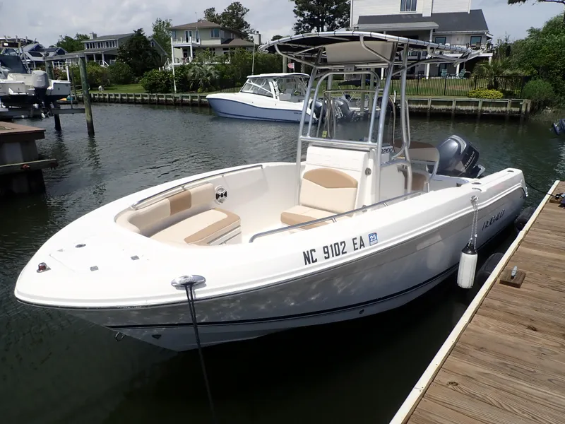 Slide: The Image of 2014 Robalo R200 Center Console boat docked in a marina. - 2