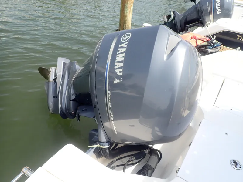 Slide: The Image of Yamaha outboard motor on 2014 Robalo R200 Center Console boat, docked on calm water. - 22