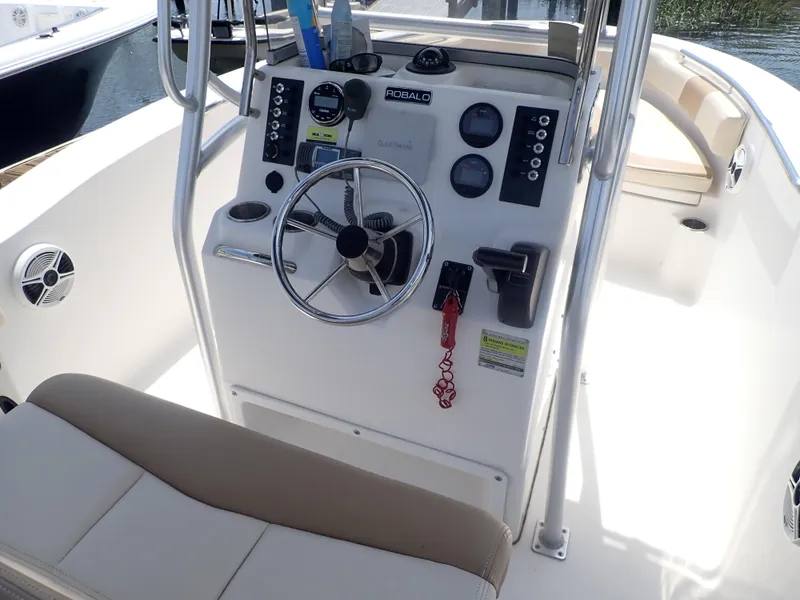 Slide: The Image of 2014 Robalo R200 Center Console boat interior with steering wheel and controls. - 24