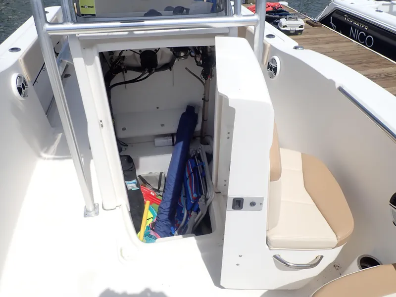 Slide: The Image of 2014 Robalo R200 Center Console boat interior with storage compartment open. - 25