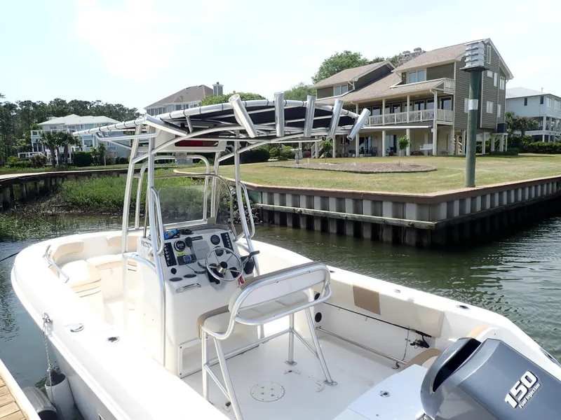Slide: The Image of 2014 Robalo R200 Center Console boat docked near waterfront homes. - 26