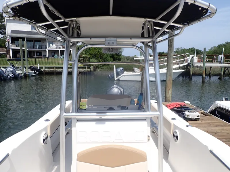 Slide: The Image of 2014 Robalo R200 Center Console boat docked in a marina, featuring a sleek design. - 4