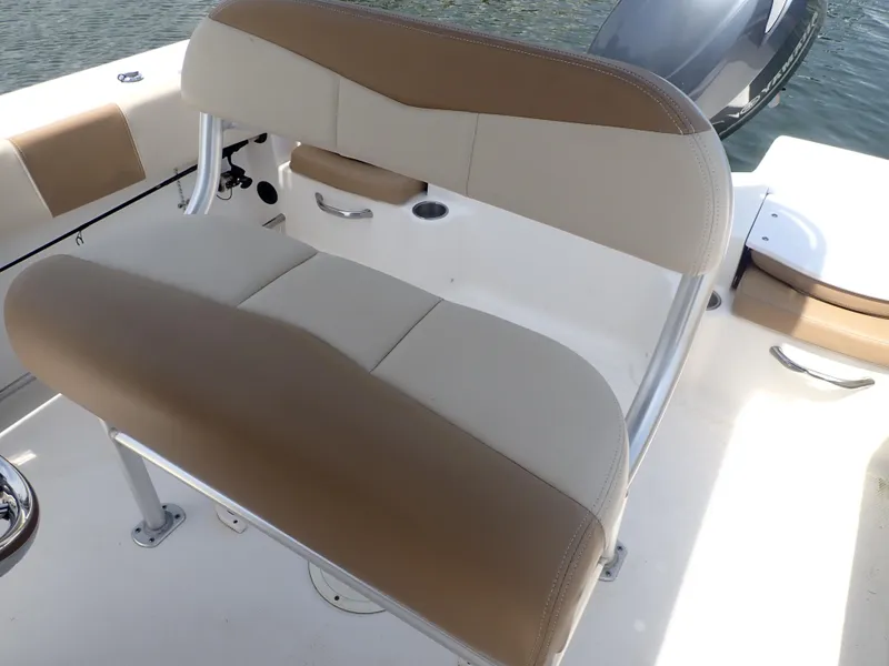 Slide: The Image of 2014 Robalo R200 Center Console boat seating with beige and white upholstery. - 7
