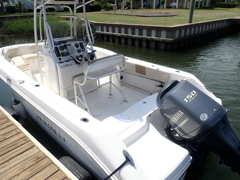 Slide: The Image of 2014 Robalo R200 Center Console boat with Yamaha 150 engine docked by the water. - 9