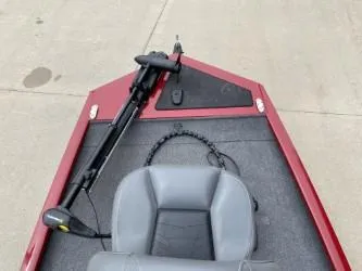 Slide: The Image of 2024 Tracker Pro 170 boat with red exterior and gray seating on concrete surface. - 2