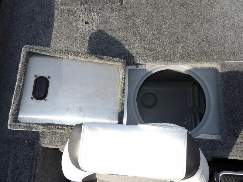 Slide: The Image of 2013 Crestliner TC Series 18 boat storage compartment with open lid and seating. - 12