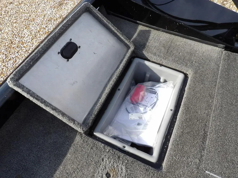 Slide: The Image of Open storage compartment in 2013 Crestliner TC Series 18 boat, containing packaged items. - 13