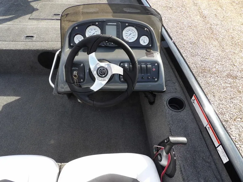 Slide: The Image of 2013 Crestliner TC Series 18 boat dashboard with steering wheel and control panel. - 17