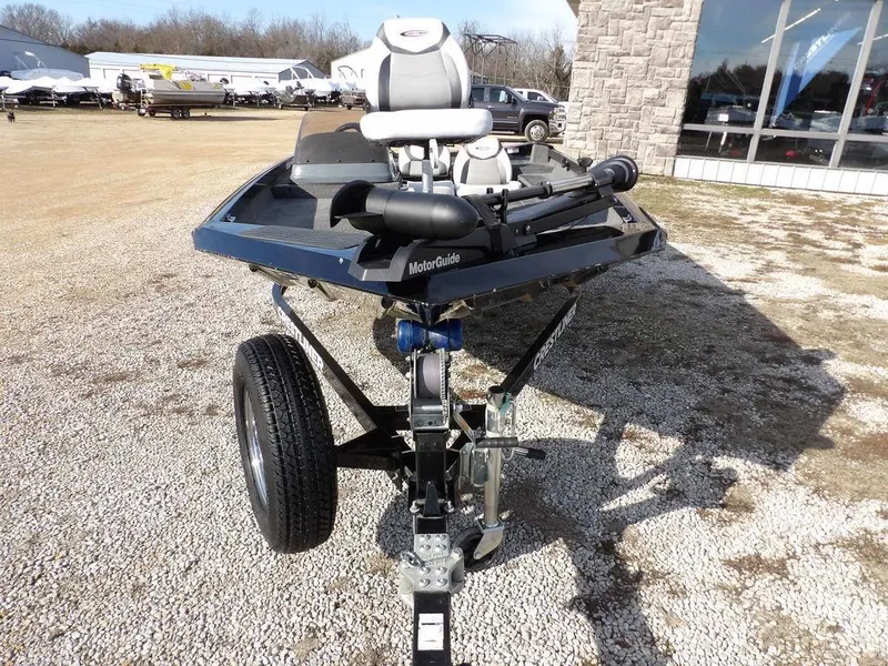 Slide: The Image of 2013 Crestliner TC Series 18 boat on trailer, parked outdoors near a building. - 2