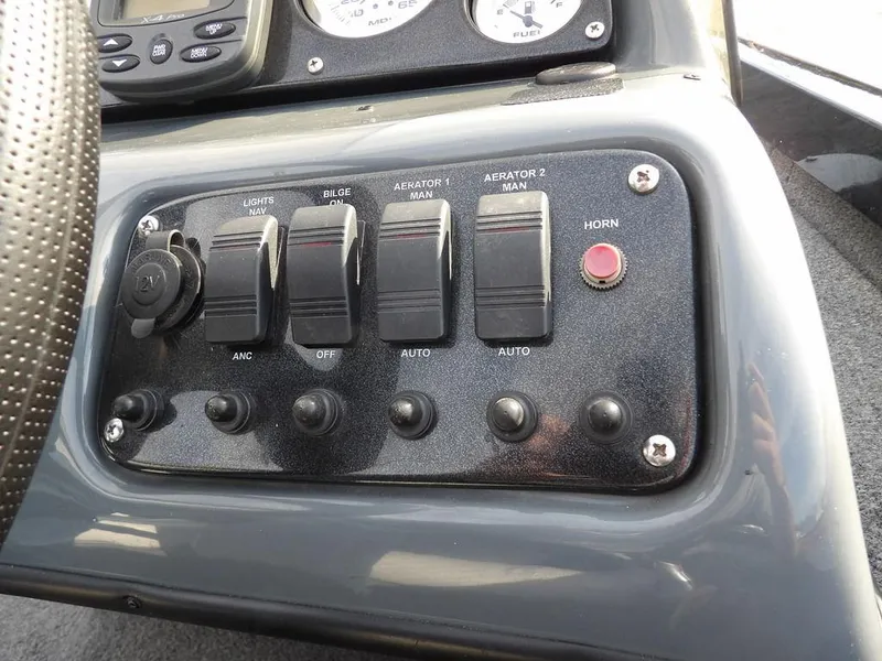 Slide: The Image of Control panel of a 2013 Crestliner TC Series 18 boat with switches and gauges. - 23