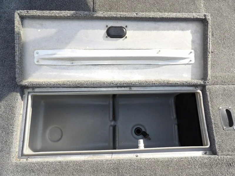 Slide: The Image of Open storage compartment in a 2013 Crestliner TC Series 18 boat, featuring a spacious interior. - 29