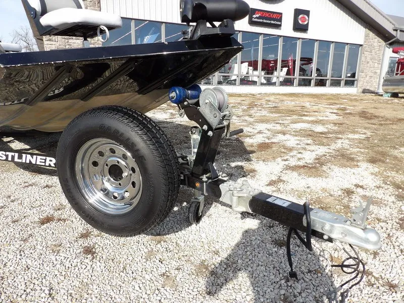 Slide: The Image of 2013 Crestliner TC Series 18 boat trailer with winch and hitch on gravel. - 36
