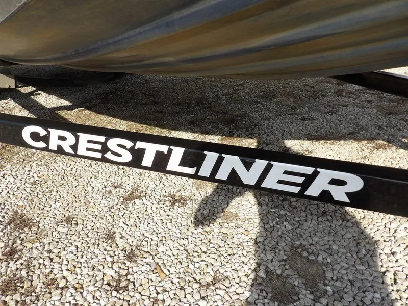 Slide: The Image of Crestliner TC Series 18 boat trailer, 2013 model, on gravel surface. - 39