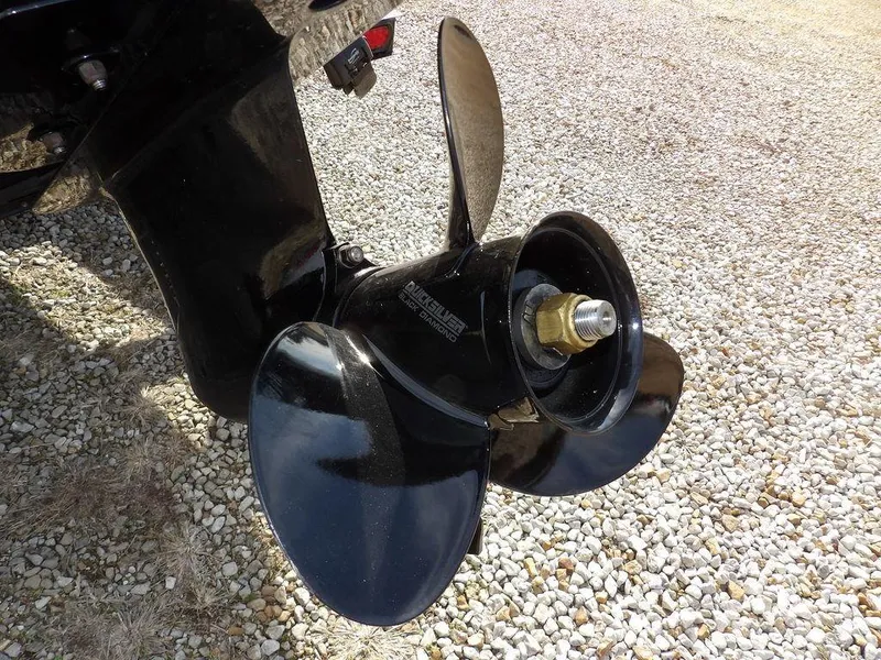 Slide: The Image of 2013 Crestliner TC Series 18 boat propeller on gravel surface. - 45