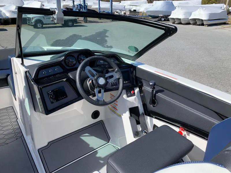 Slide: The Image of 2023 MasterCraft NXT20 boat interior with steering wheel and dashboard controls. - 10