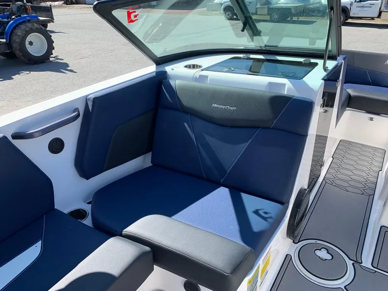 Slide: The Image of 2023 MasterCraft NXT20 boat interior with blue seating and modern design. - 11
