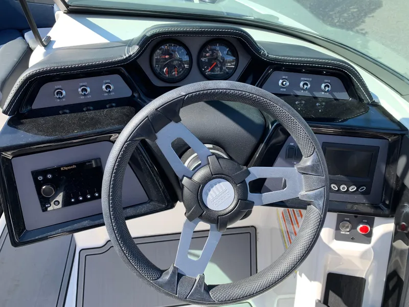 Slide: The Image of 2023 MasterCraft NXT20 dashboard with steering wheel and control panels. - 12