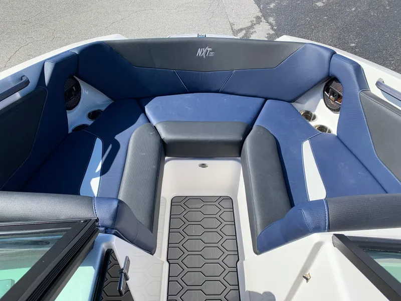 Slide: The Image of 2023 MasterCraft NXT20 boat interior with blue seating and hexagonal floor design. - 13