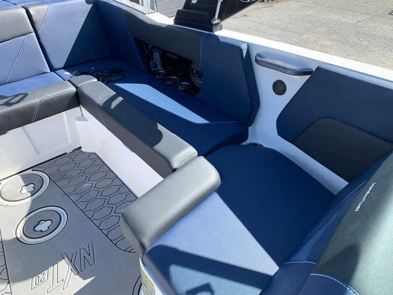 Slide: The Image of 2023 MasterCraft NXT20 boat interior with blue seating and custom flooring. - 15