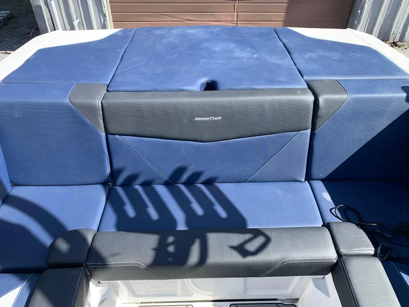 Slide: The Image of 2023 MasterCraft NXT20 boat interior with blue and black seating. - 18