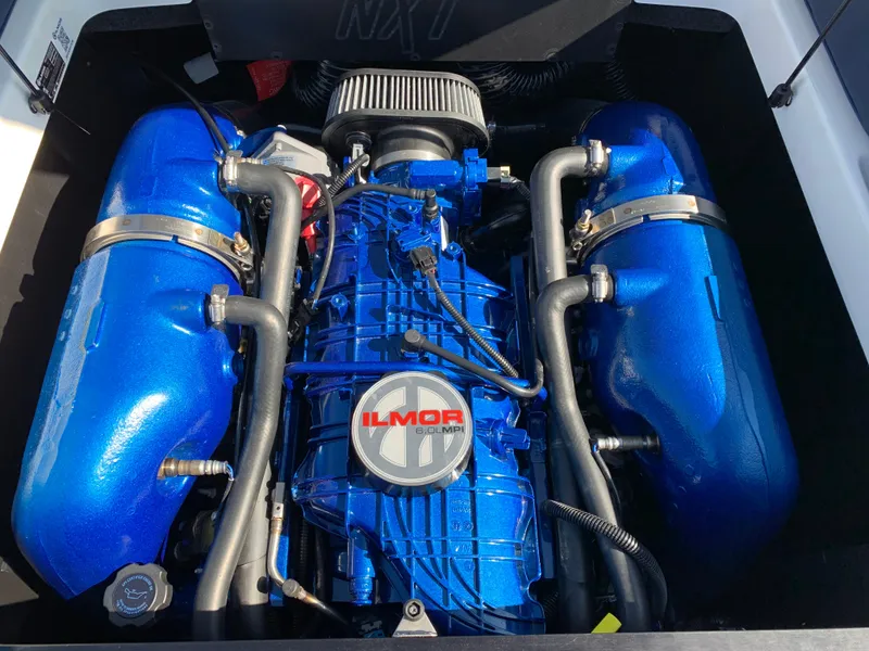 Slide: The Image of 2023 MasterCraft NXT20 Ilmor engine with blue components and detailed piping. - 19