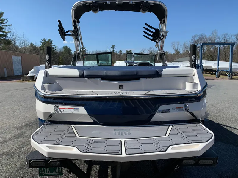 Slide: The Image of 2023 MasterCraft NXT20 boat rear view with swim platform and wakeboard tower. - 7