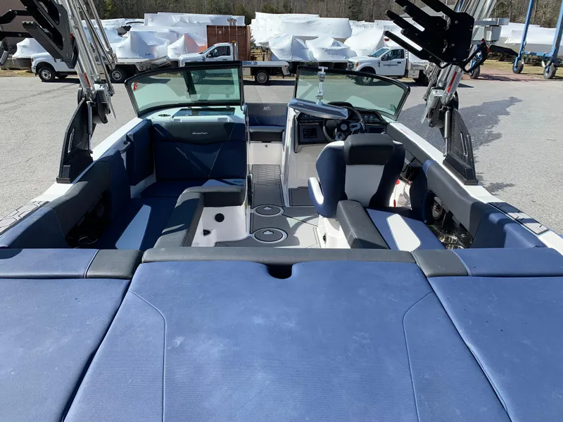 Slide: The Image of 2023 MasterCraft NXT20 boat interior with blue seating and modern dashboard. - 9