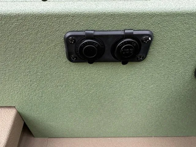 Slide: The Image of 2025 SeaArk Easy 200 boat with dual power outlets on green panel. - 11