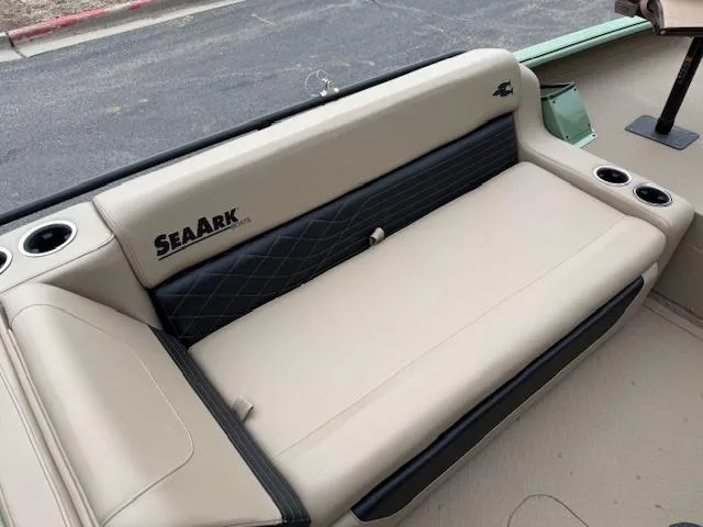 Slide: The Image of 2025 SeaArk Easy 200 boat interior with beige seating and cup holders. - 17