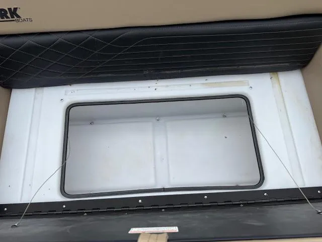 Slide: The Image of Interior view of a 2025 SeaArk Easy 200 boat storage compartment. - 18
