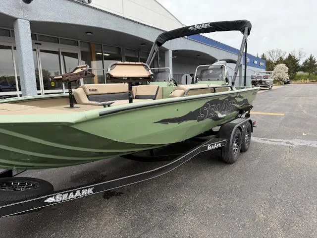 Slide: The Image of 2025 SeaArk Easy 200 boat with Suzuki DF200 engine on trailer, parked outside a building. - 2