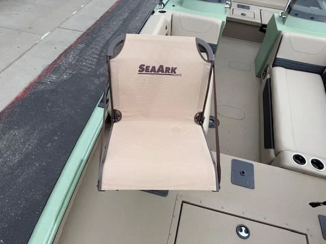 Slide: The Image of 2025 SeaArk Easy 200 boat interior with beige seating and storage compartments. - 23