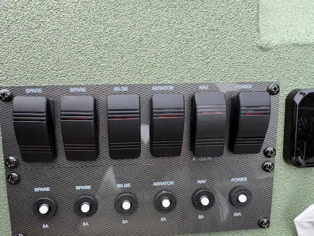 Slide: The Image of Control panel of SeaArk Easy 200 boat, featuring switches for bilge, aerator, navigation, and power. - 7