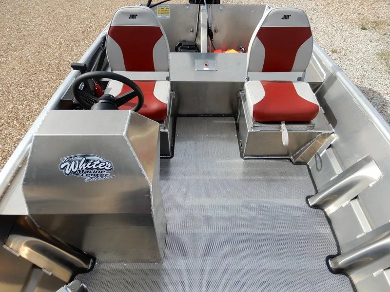 Slide: The Image of 2025 Blazer 1752 SS boat interior with red and white seats, steering wheel, and metal flooring. - 15