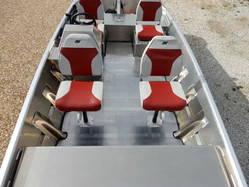 Slide: The Image of 2025 Blazer 1752 SS boat interior with red and white seats, steering wheel, and metal flooring. - 17