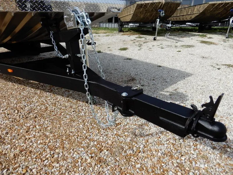 Slide: The Image of Trailer hitch of 2025 Blazer 1752 SS on gravel, featuring safety chains and coupler. - 29