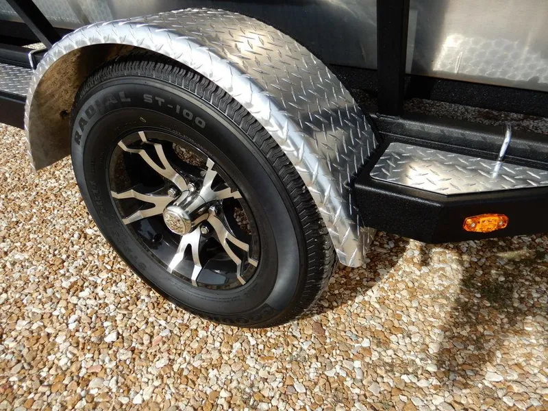 Slide: The Image of 2025 Blazer 1752 SS trailer wheel with diamond plate fender on gravel surface. - 30