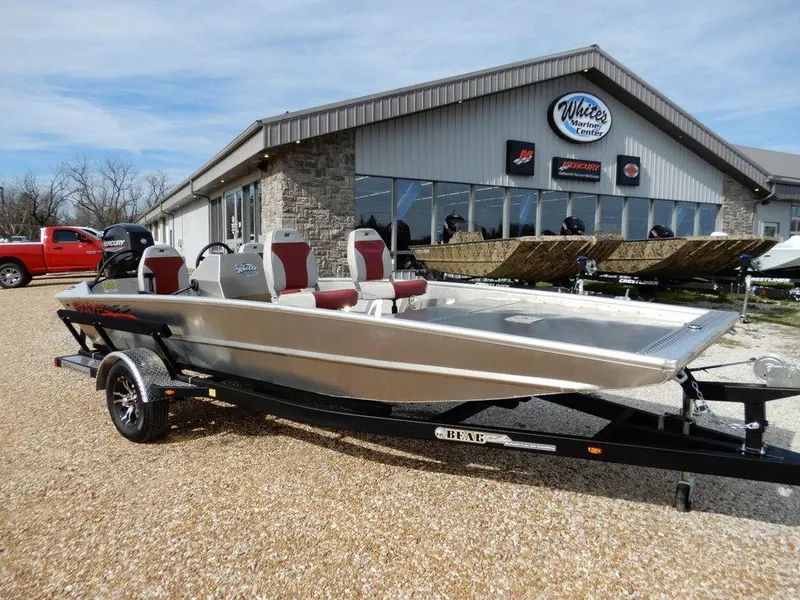 Slide: The Image of 2025 Blazer 1752 SS boat on trailer outside dealership, featuring sleek design and red seating. - 33