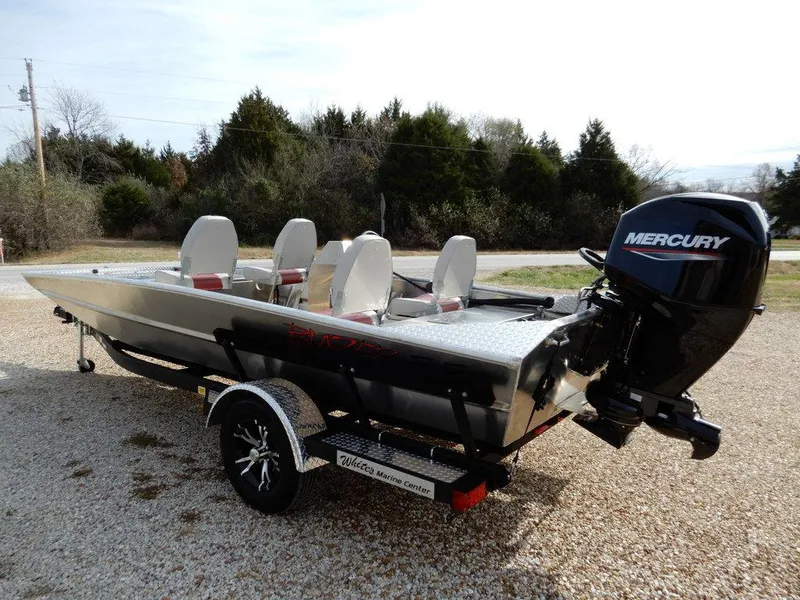 Slide: The Image of 2025 Blazer 1752 SS boat with Mercury engine on a trailer, parked outdoors. - 5