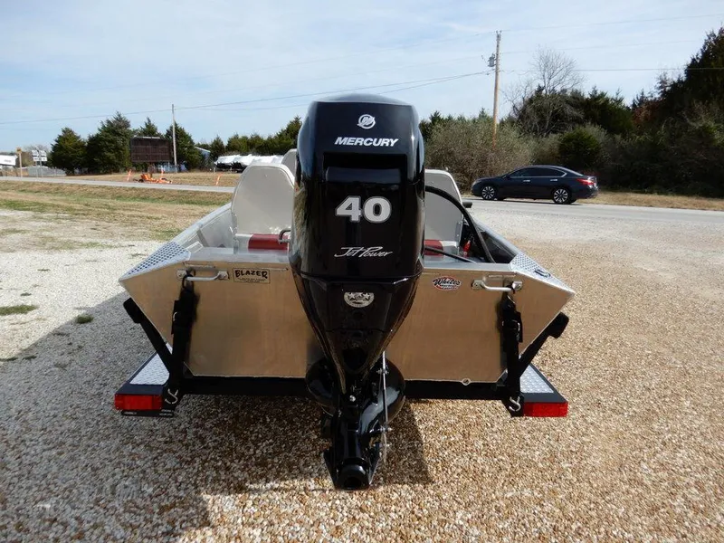 Slide: The Image of 2025 Blazer 1752 SS boat with Mercury 40 HP engine, parked on gravel. - 6