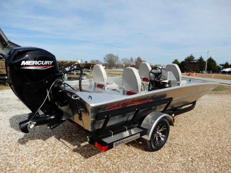 Slide: The Image of 2025 Blazer 1752 SS boat with Mercury engine on a trailer, parked outdoors. - 7