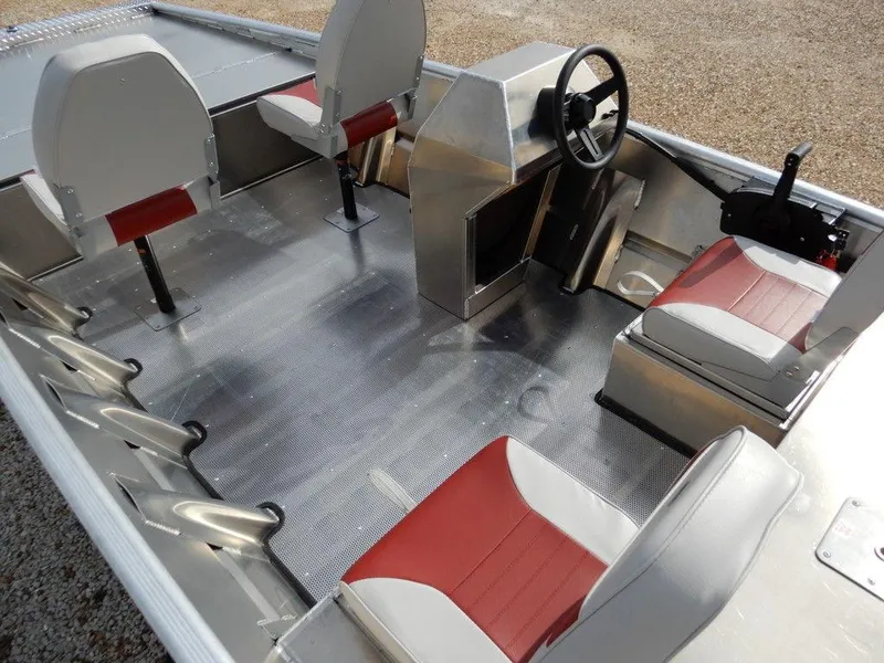 Slide: The Image of 2025 Blazer 1752 SS boat interior with red and white seats, steering console, and aluminum flooring. - 9