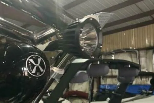 Slide: The Image of 2017 MB B52 21 Classic boat detail with spotlight and logo in a warehouse setting. - 4