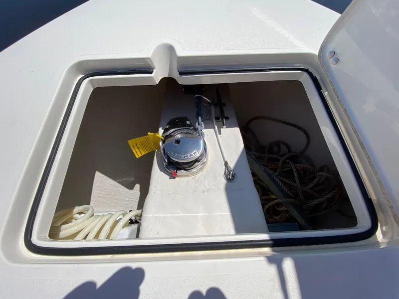 Slide: The Image of 2022 Cobia 301 Center Console anchor locker with ropes and winch. - 13