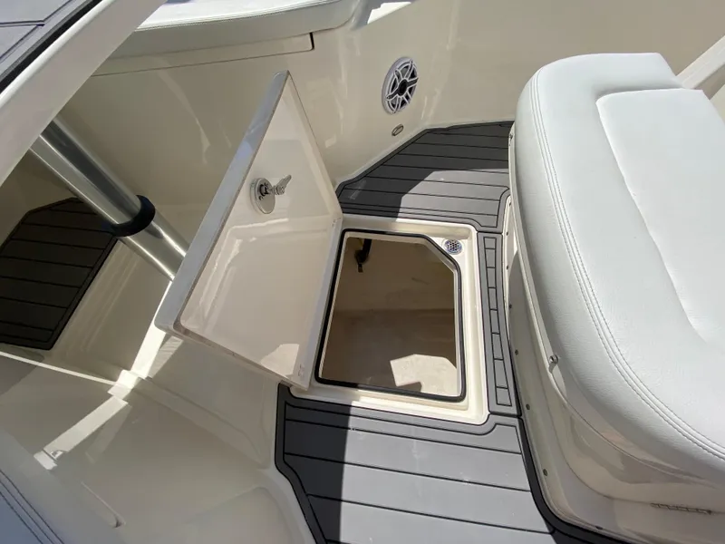 Slide: The Image of 2022 Cobia 301 Center Console boat interior with open storage compartment. - 15