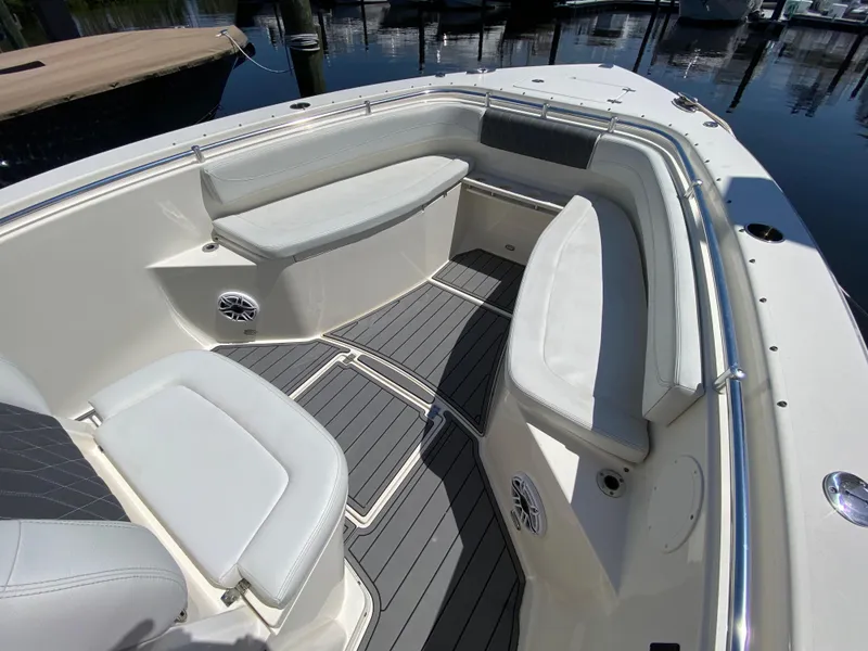 Slide: The Image of 2022 Cobia 301 Center Console boat interior with cushioned seating and sleek design. - 21