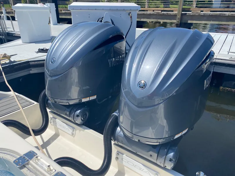 Slide: The Image of Twin Yamaha outboard engines on a 2022 Cobia 301 Center Console boat. - 24