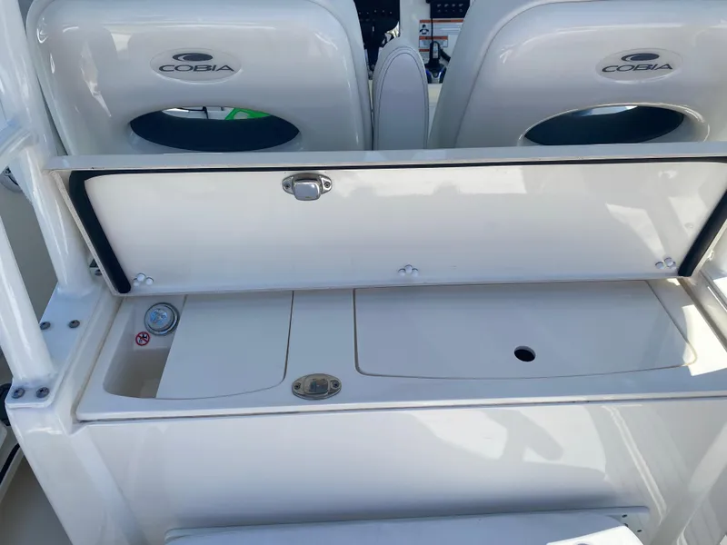 Slide: The Image of 2022 Cobia 301 Center Console boat interior with storage compartment open. - 29