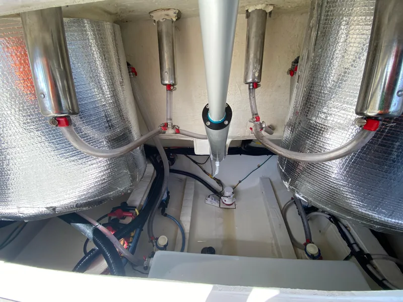 Slide: The Image of 2022 Cobia 301 Center Console boat engine compartment with insulated components and wiring. - 35